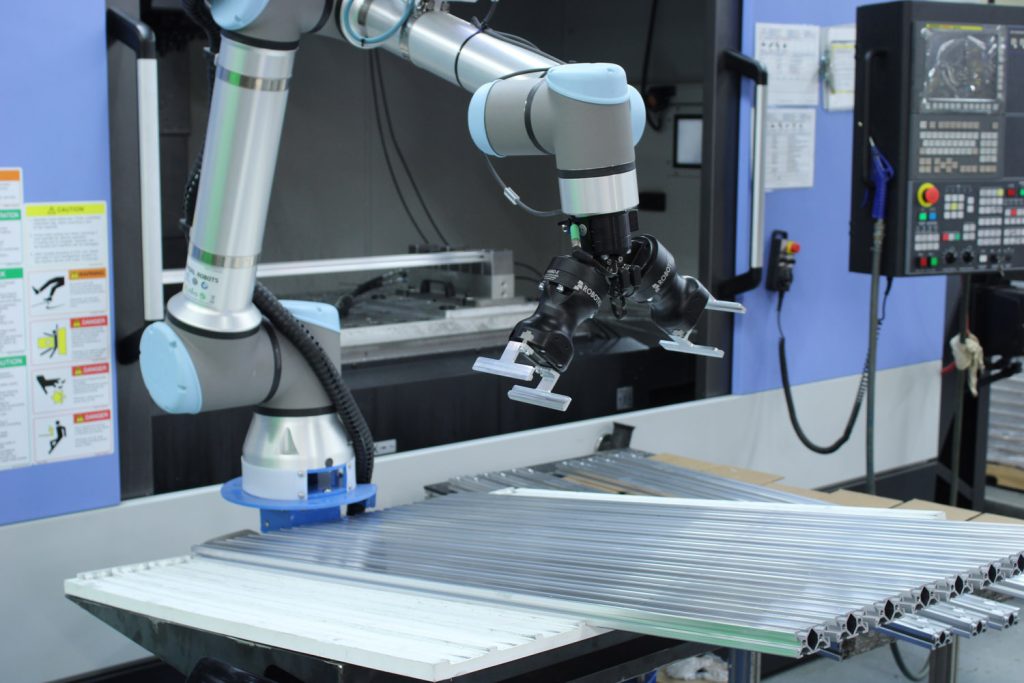Extruded aluminum T-slot collaborative robot station for automated manufacturing