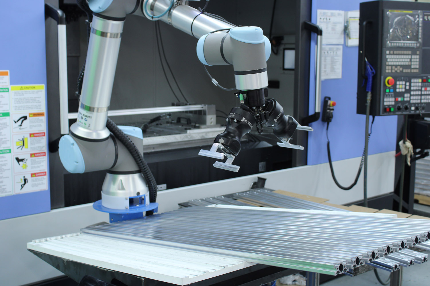 Extruded aluminum T-slot collaborative robot station for automated manufacturing